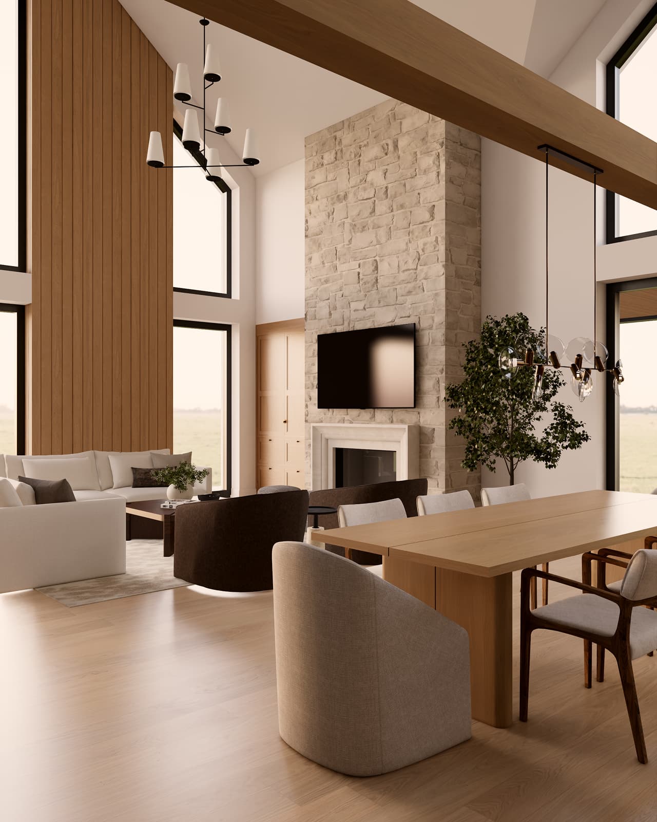 Odprt bivalni prostor s kamnitim kaminom in masivno leseno mizo